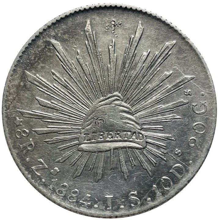 Reverse of 1884 Zacatecas Zs JS Republican Cap-and-Rays 8 Reales with merchant chopmarks