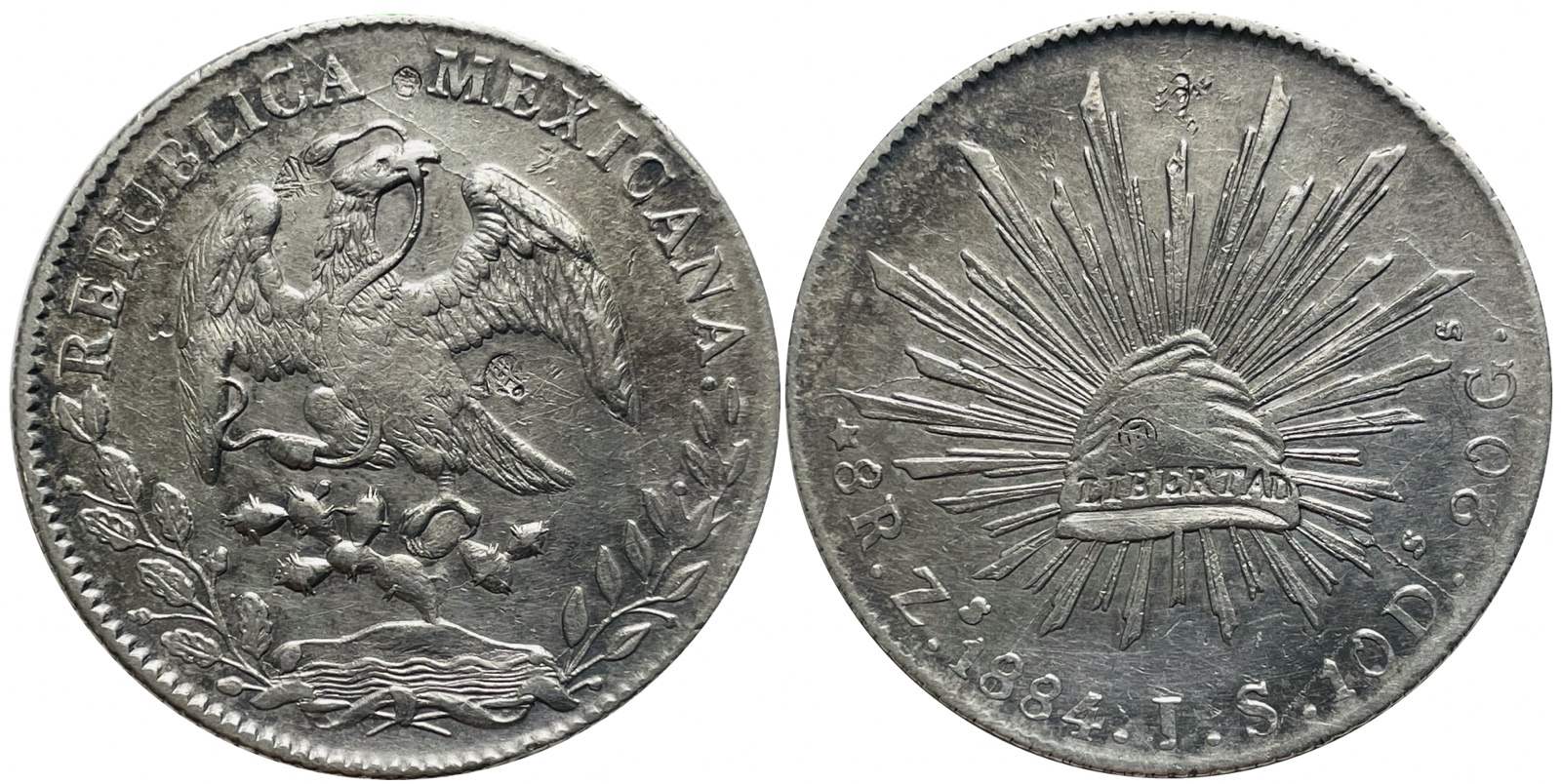 1884 Zacatecas Zs JS Mexican 8 reales with visible circulation chopmarks — left face